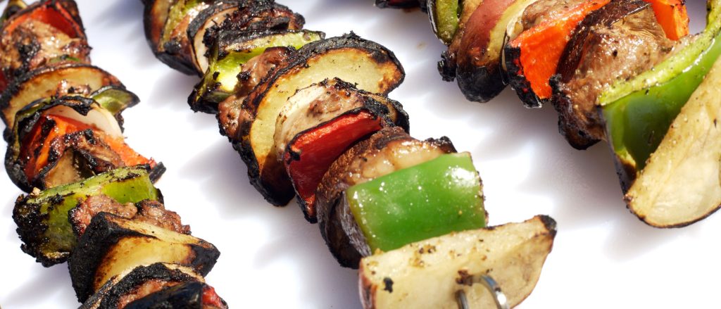 Grilled lamb and vegetable skewers with zucchini and peppers, marinated with fresh herbs and lemon juice.
