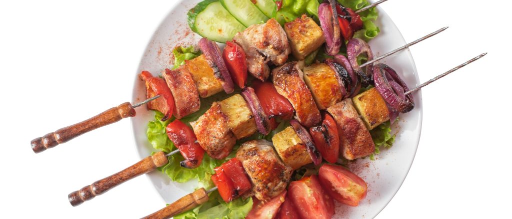 Grilled skewers with marinated pork, pineapple, and vegetables, perfect for a flavorful summer meal.