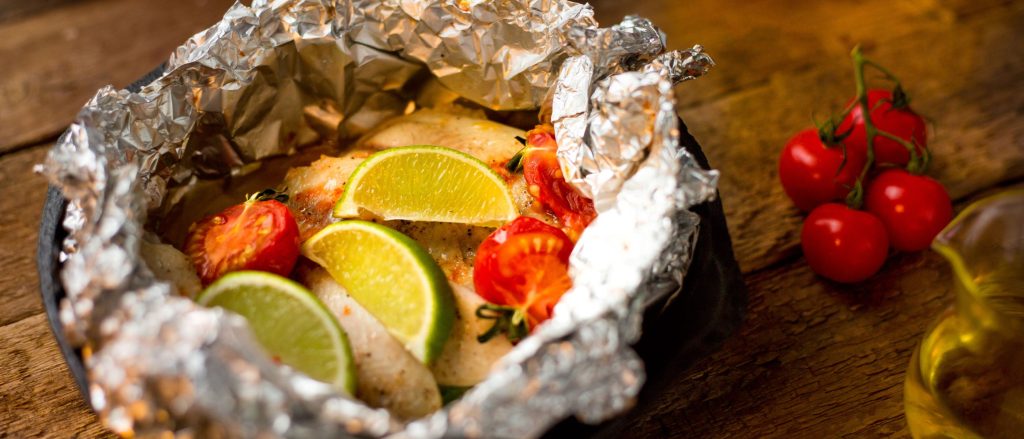 Fish and vegetable foil packet with cherry tomatoes
