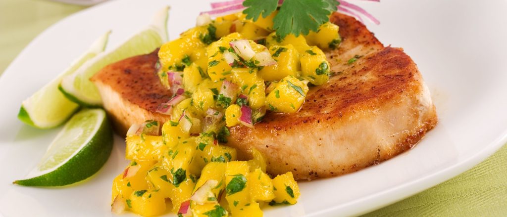 Grilled swordfish topped with fresh mango salsa