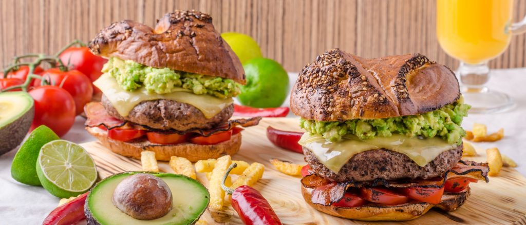 Juicy elk burger topped with avocado slices