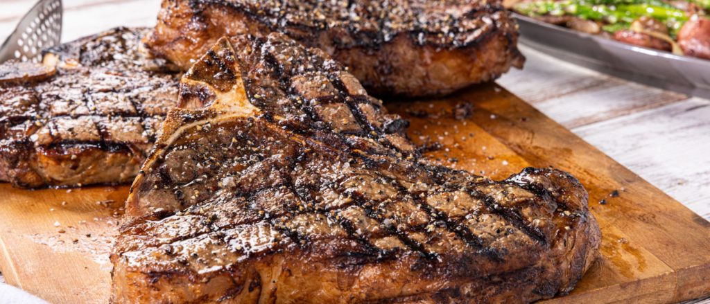 Juicy porterhouse steak grilled to perfection, served with a medley of grilled baby red potatoes, fennel, and asparagus in a red wine butter sauce.