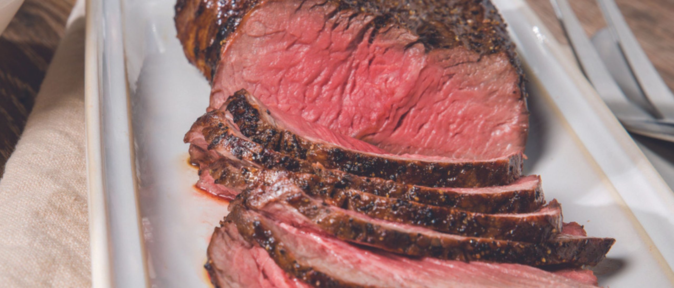 A perfectly broiled London broil sliced thinly and served with a sweet and spicy bourbon sauce.