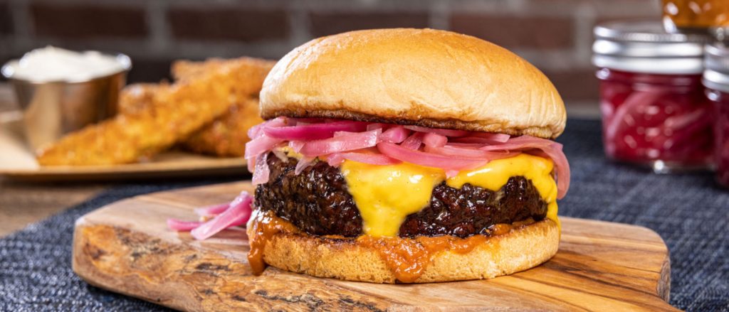 Smoked burgers with a coffee-infused BBQ sauce and pickled red onions.
