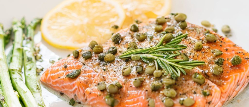 Grilled salmon fillets with rosemary, lemon, and capers.