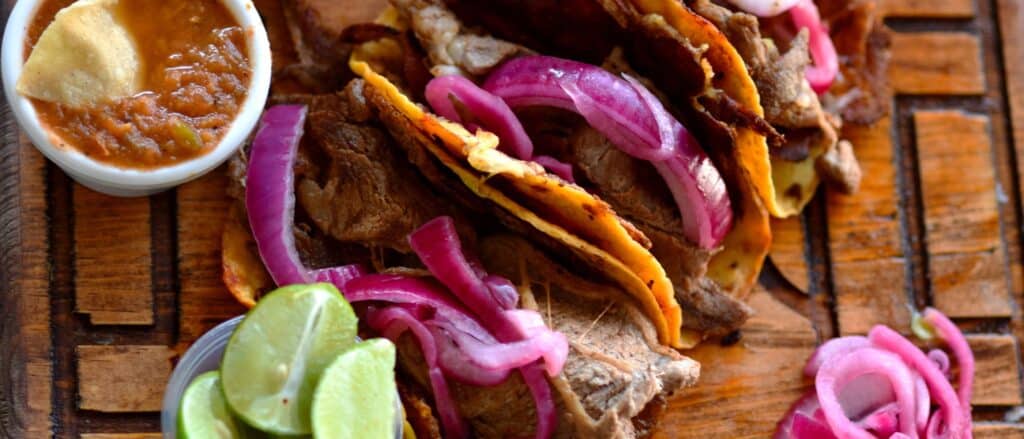 Steak tacos with red onion slices